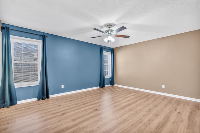 unfurnished room featuring ceiling fan, light hardwood / wood-style flooring, and a textured ceiling