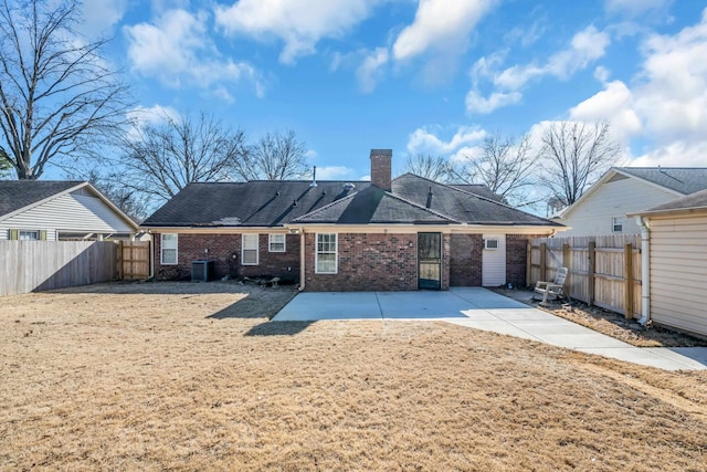 back of property with cooling unit and a patio area