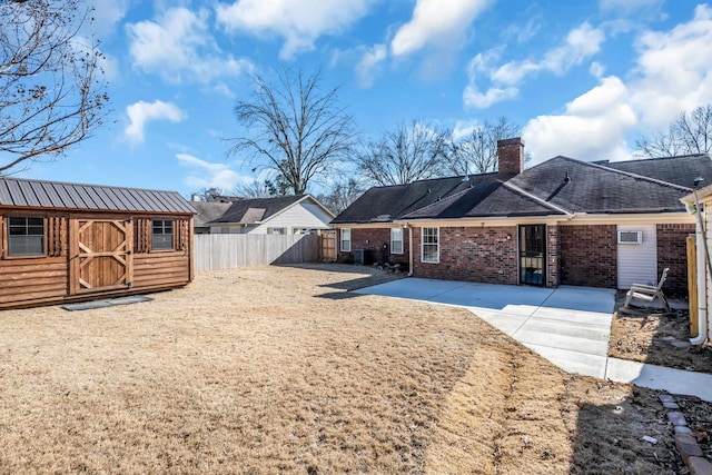 rear view of house with a storage shed, central AC unit, and a patio