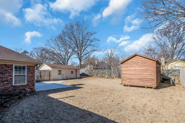 view of yard featuring a patio and a storage shed