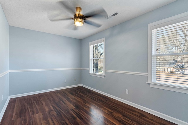 unfurnished room with ceiling fan and dark hardwood / wood-style flooring