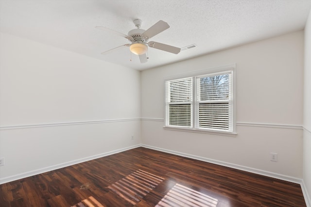 empty room featuring ceiling fan and dark hardwood / wood-style flooring