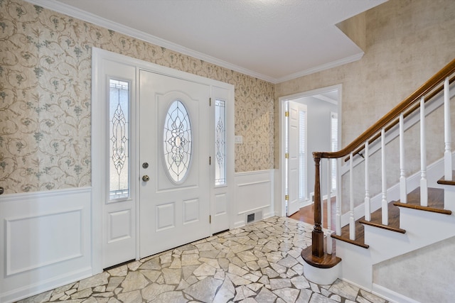 entrance foyer featuring ornamental molding