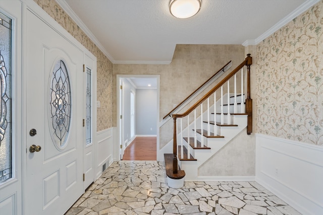 foyer entrance featuring ornamental molding