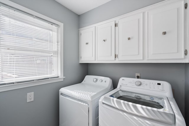 laundry room with cabinets and washer and clothes dryer