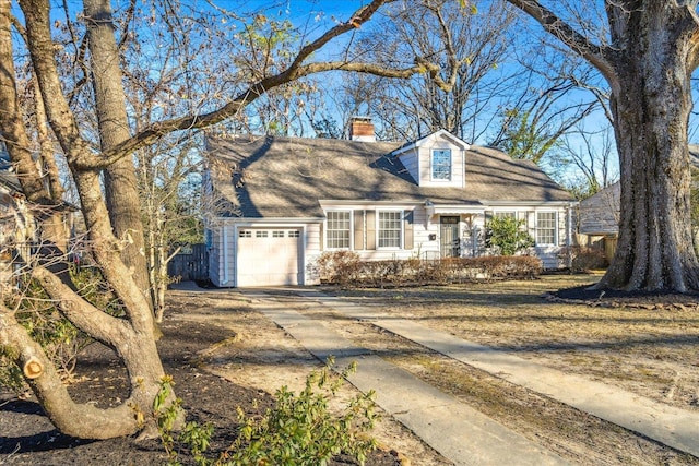 cape cod-style house featuring a garage