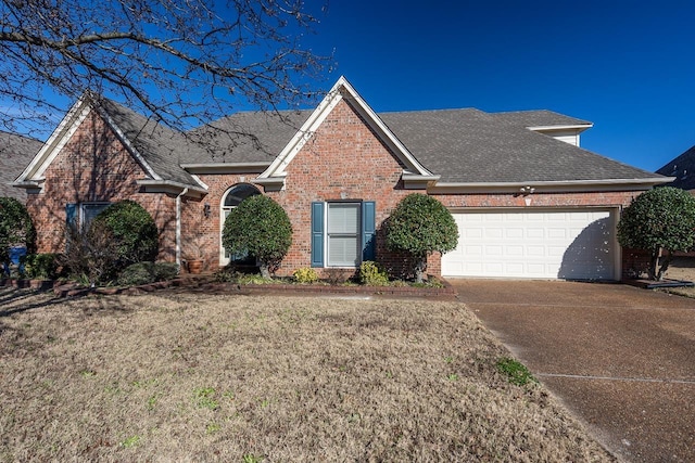 view of property with a garage and a front yard