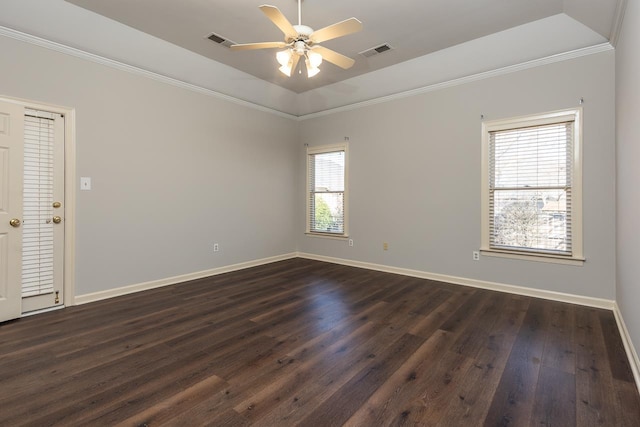 empty room with dark wood-type flooring, lofted ceiling, ornamental molding, a raised ceiling, and ceiling fan