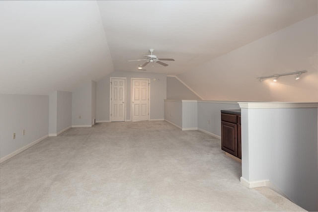 additional living space with ceiling fan, vaulted ceiling, and light carpet