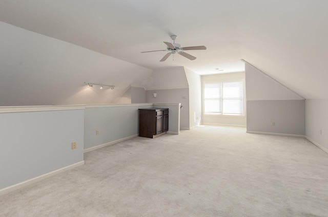 additional living space featuring lofted ceiling, light colored carpet, and ceiling fan