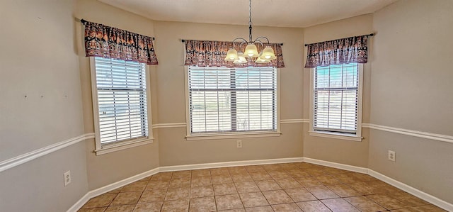 unfurnished dining area featuring tile patterned flooring and an inviting chandelier