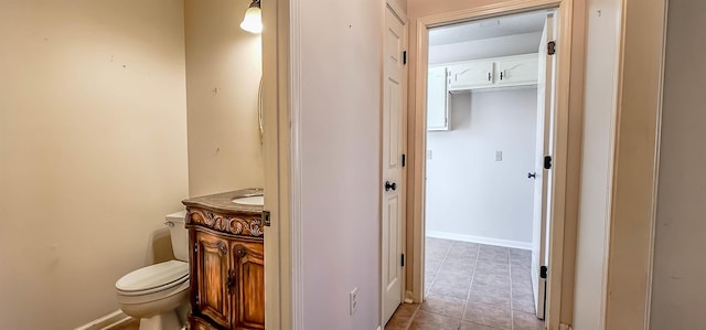 bathroom with tile patterned floors, vanity, and toilet