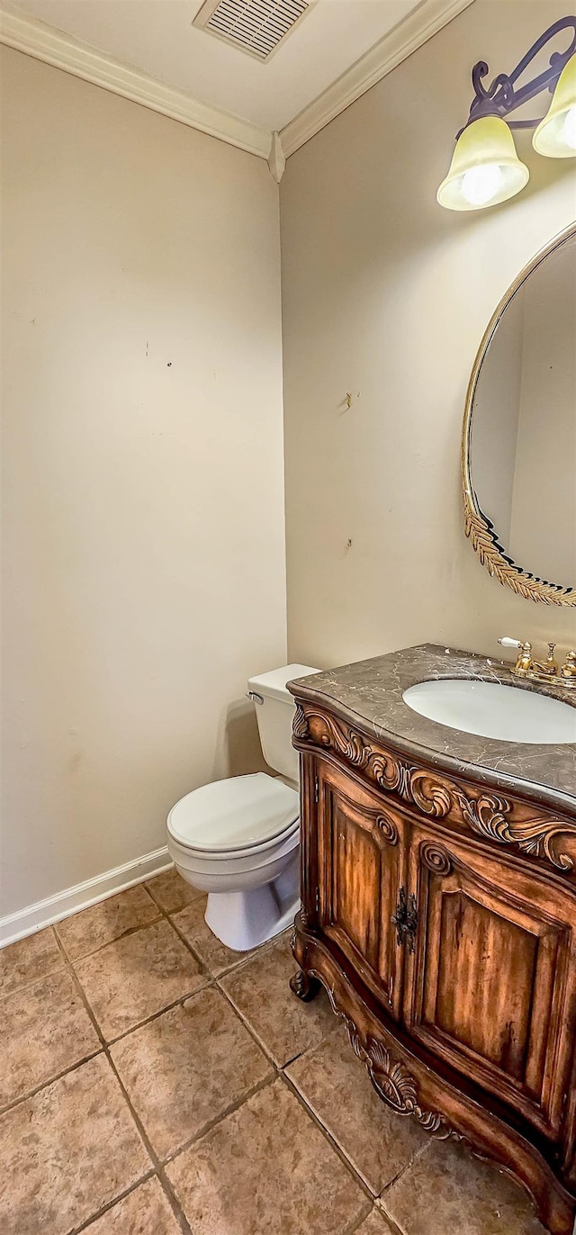 bathroom featuring crown molding, vanity, tile patterned floors, and toilet