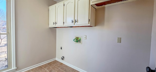 washroom featuring electric dryer hookup, light tile patterned floors, hookup for a washing machine, and cabinets