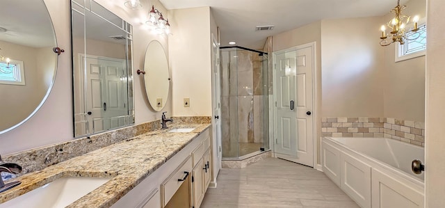 bathroom featuring independent shower and bath, vanity, tile patterned floors, and an inviting chandelier