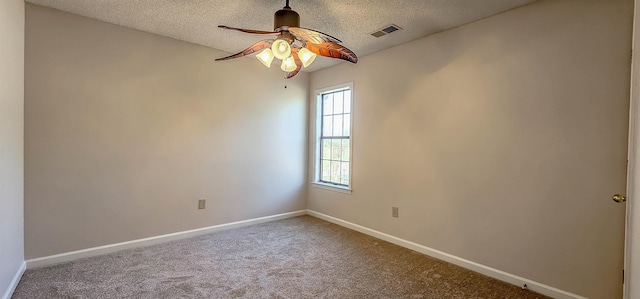 carpeted empty room featuring ceiling fan and a textured ceiling