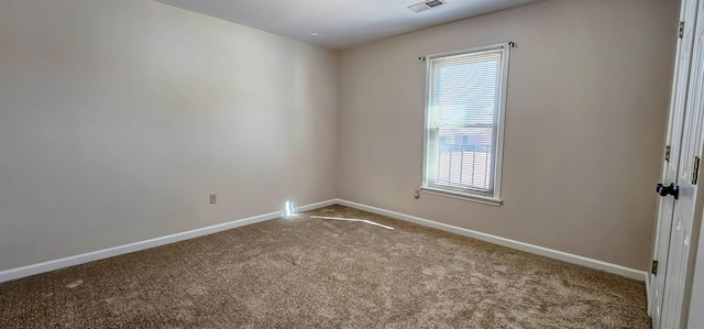 unfurnished room featuring light carpet