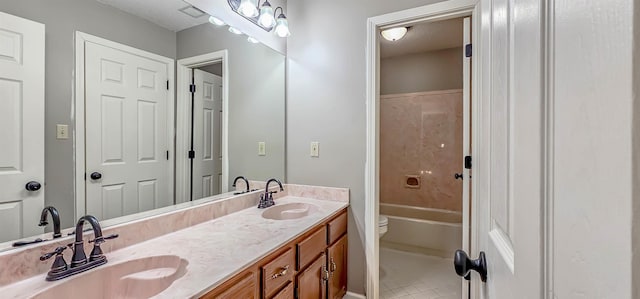 full bathroom with bathtub / shower combination, vanity, toilet, and tile patterned flooring