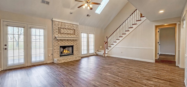 unfurnished living room featuring ceiling fan, dark hardwood / wood-style flooring, high vaulted ceiling, and a brick fireplace