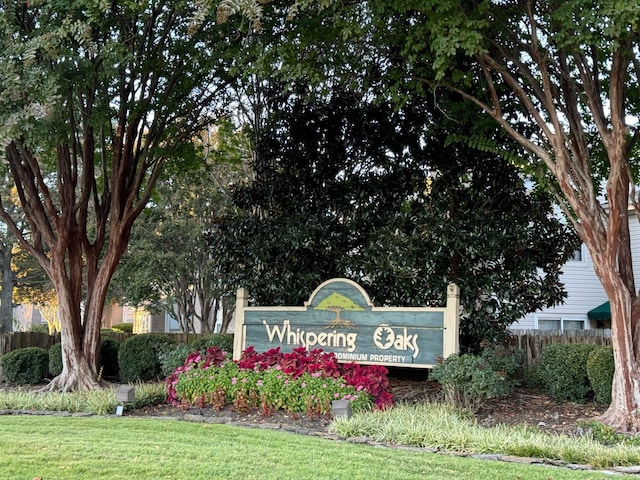 community sign featuring a lawn