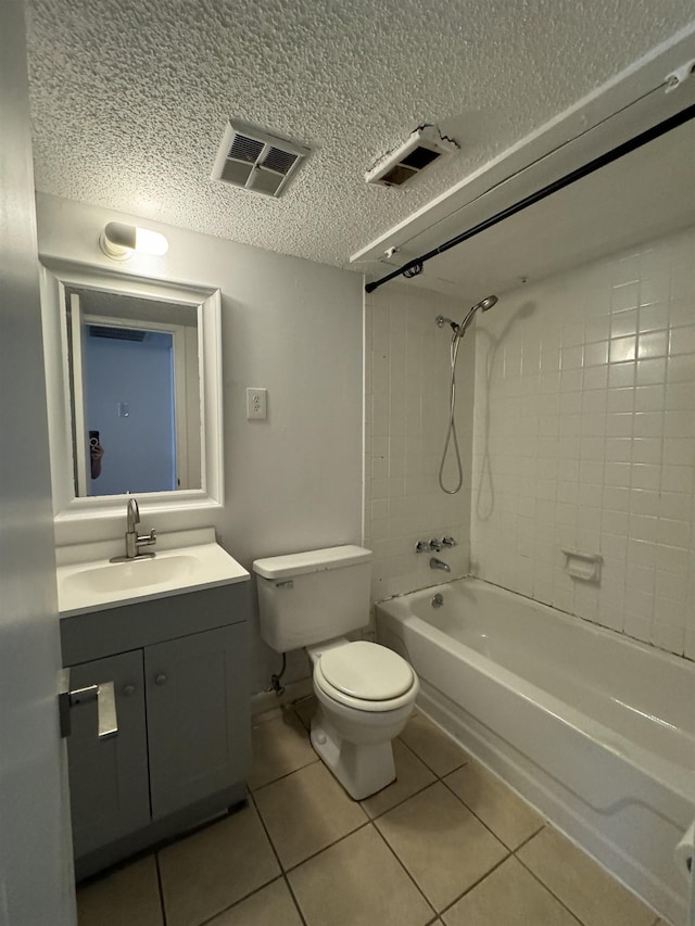 full bathroom with tile patterned flooring, vanity, tiled shower / bath combo, and toilet