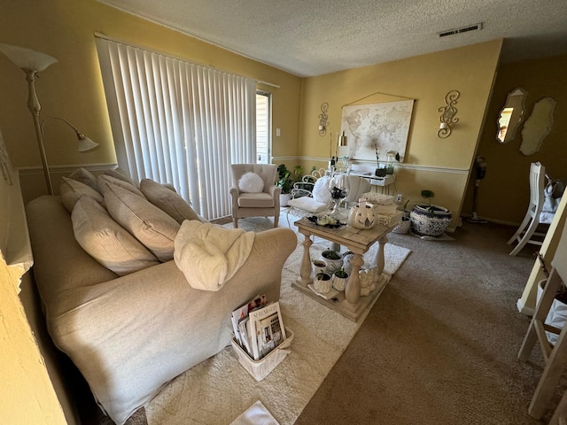 living room with a textured ceiling and carpet flooring