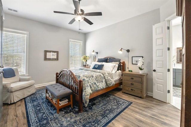 bedroom featuring multiple windows, ceiling fan, and light hardwood / wood-style flooring