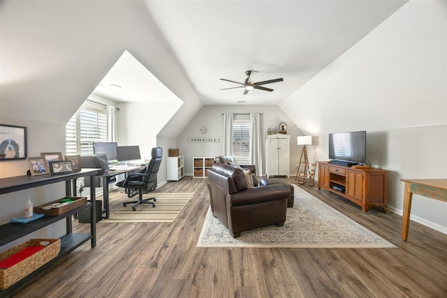 office area featuring vaulted ceiling, a wealth of natural light, ceiling fan, and dark hardwood / wood-style flooring