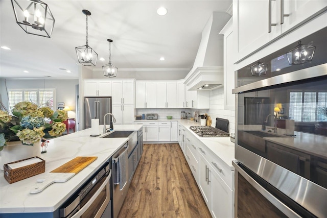 kitchen with custom exhaust hood, appliances with stainless steel finishes, white cabinets, and decorative backsplash