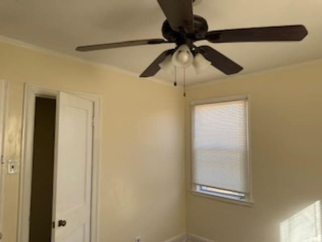 unfurnished room featuring crown molding and ceiling fan