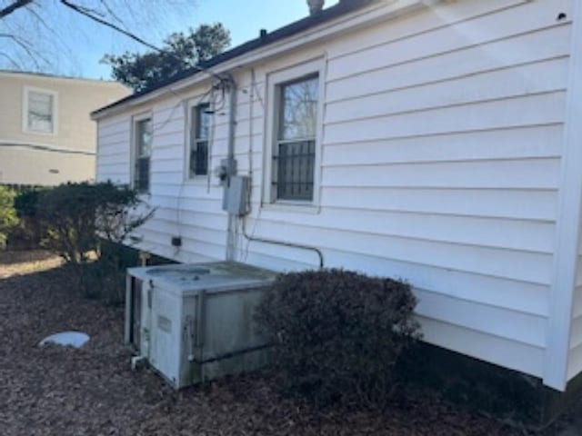 view of side of property with ac unit