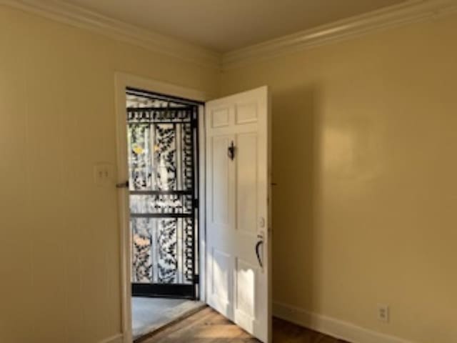 entryway with crown molding and light wood-type flooring