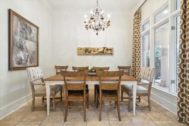 dining space with ornamental molding and a chandelier