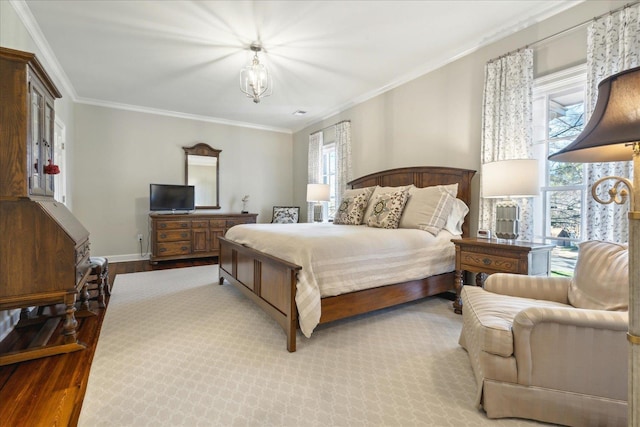 bedroom featuring multiple windows, crown molding, and light hardwood / wood-style flooring