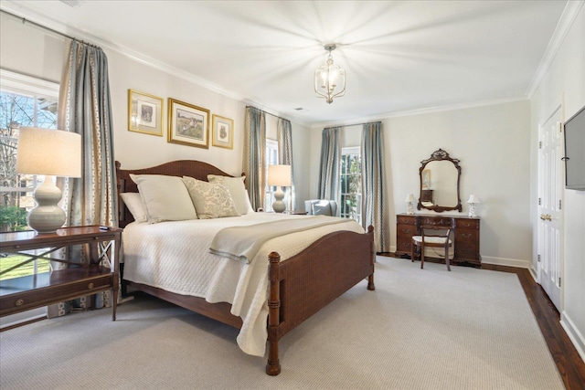 bedroom with an inviting chandelier, hardwood / wood-style floors, and ornamental molding