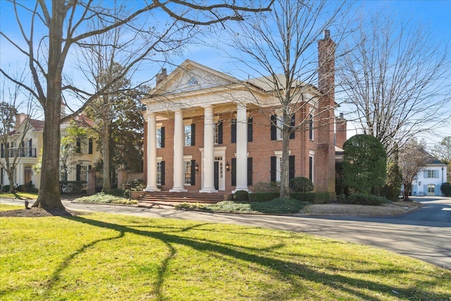 neoclassical home with a front lawn