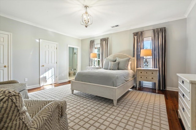 bedroom with crown molding, ensuite bath, wood-type flooring, and an inviting chandelier