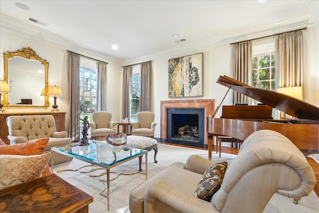 sitting room featuring crown molding and plenty of natural light