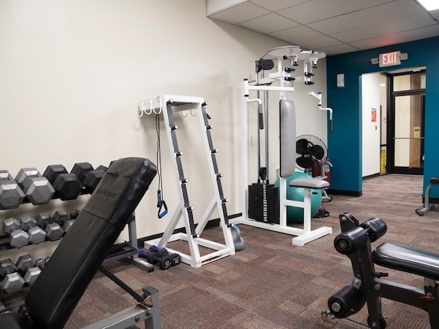 gym with a paneled ceiling