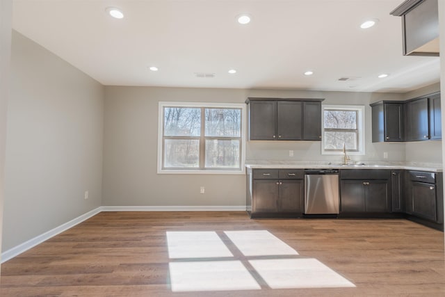 kitchen featuring dark brown cabinetry, sink, light hardwood / wood-style flooring, and dishwasher