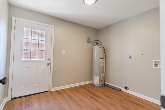 laundry area with washer hookup, electric water heater, hookup for an electric dryer, and light wood-type flooring