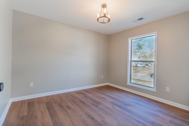 unfurnished room with wood-type flooring