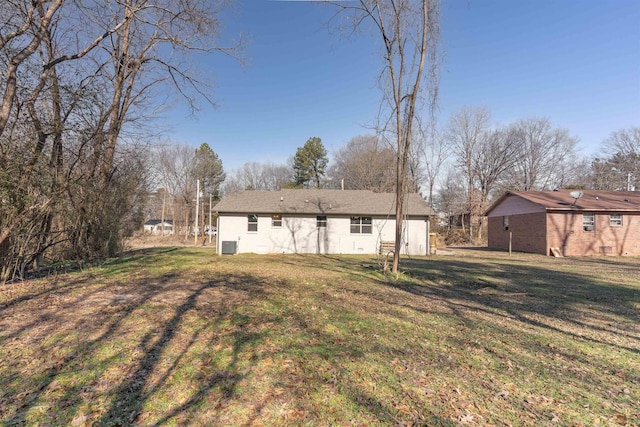 rear view of house featuring a yard