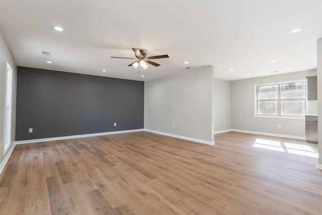 unfurnished room with ceiling fan and light wood-type flooring