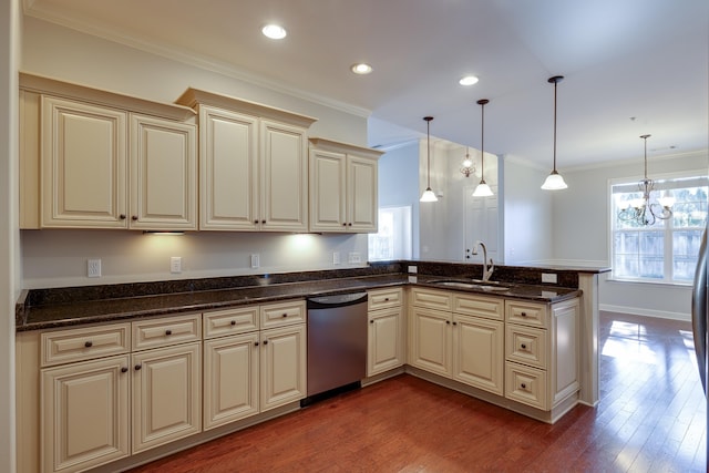 kitchen with sink, decorative light fixtures, cream cabinets, and stainless steel dishwasher