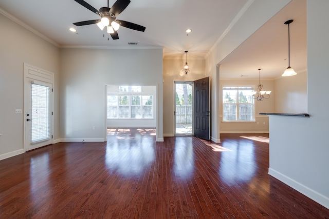 unfurnished living room with dark hardwood / wood-style flooring, crown molding, and ceiling fan with notable chandelier