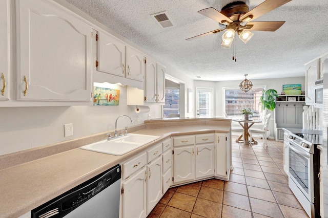 kitchen featuring sink, light tile patterned floors, stainless steel appliances, and white cabinets