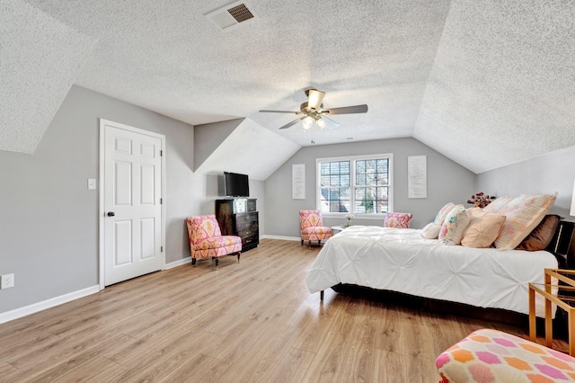 bedroom featuring lofted ceiling, ceiling fan, and light wood-type flooring