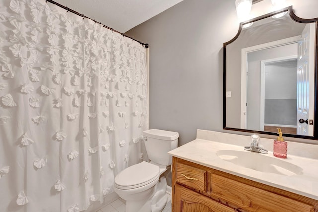 bathroom with vanity, tile patterned floors, toilet, and a textured ceiling