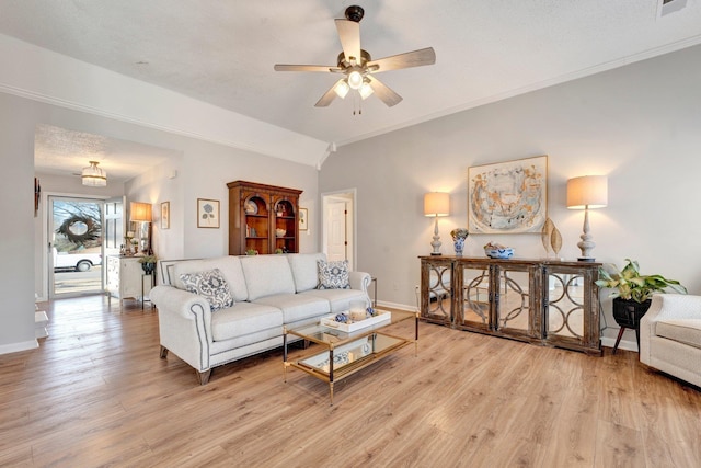 living room with lofted ceiling, crown molding, light hardwood / wood-style flooring, ceiling fan, and a textured ceiling